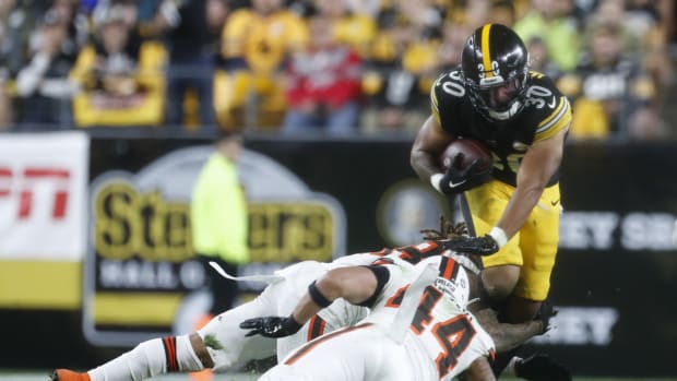 Sep 18, 2023; Pittsburgh, Pennsylvania, USA; Pittsburgh Steelers running back Jaylen Warren (30) runs the ball against Cleveland Browns cornerback Mike Ford (rear) and linebacker Sione Takitaki (44) during the third quarter at Acrisure Stadium. Pittsburgh won 26-22. Mandatory Credit: Charles LeClaire-USA TODAY Sports